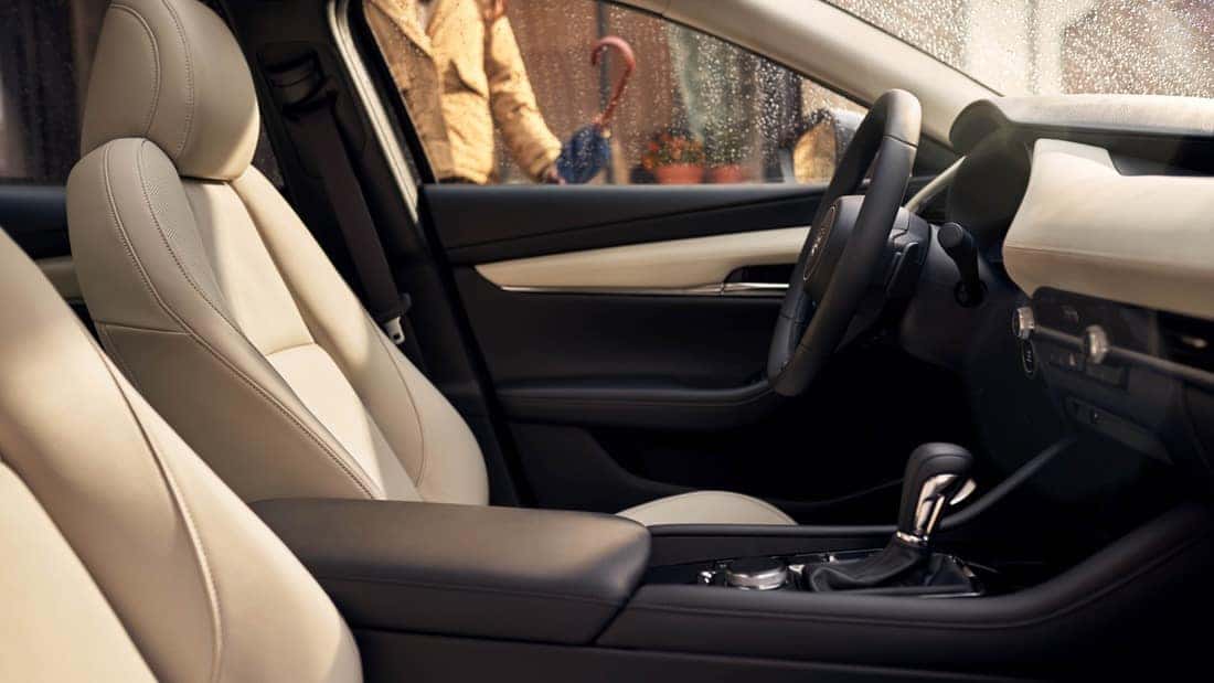 The interior of a 2025 Mazda3, showcasing a modern dashboard, comfortable seating, and premium materials.