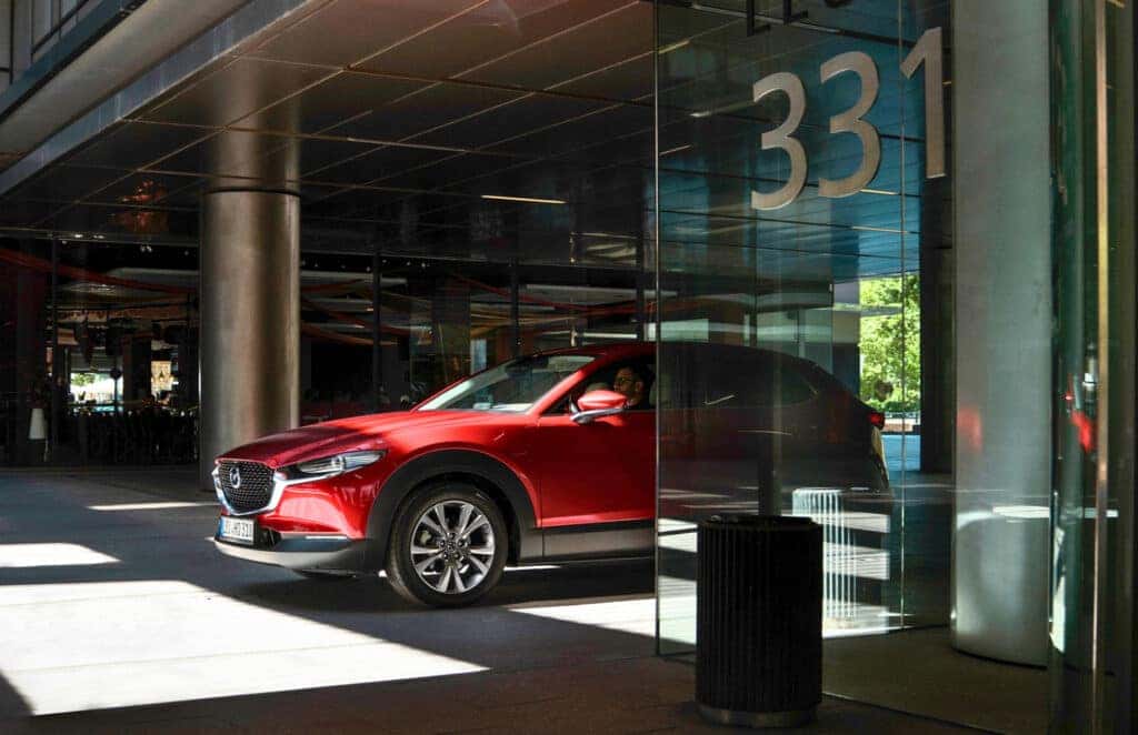 1. A sleek 2024 Mazda CX-30 SUV showcasing its stylish design, comfort, and practicality in a modern setting.
