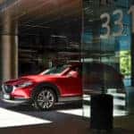 A sleek 2024 Mazda CX-30 SUV showcasing its stylish design, comfort, and practicality in a modern setting.