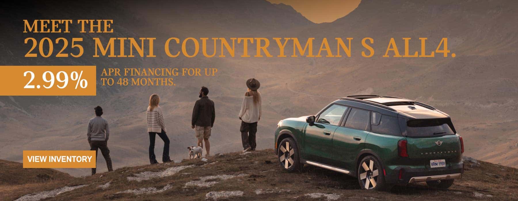 MINI Countryman parked with a family of 4 and their dog on a snow hill across a valley in the mountains.
