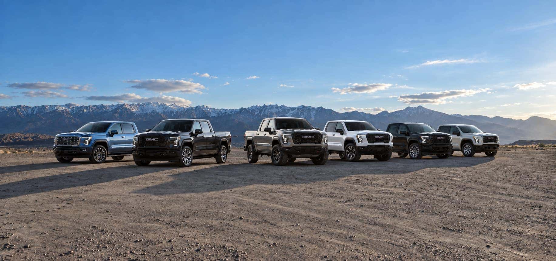 Pack shot of the 2027 GMC Sierra 1500 Denali in Azurite Blue Metallic, Denali Ultimate in Dark Ridge Metallic, AT4X in Sterling Metallic, AT4 in Summit White, Elevation in Onyx Black and Pro in Coastal Dune (left to right). Preproduction models shown. Actual production models may vary.