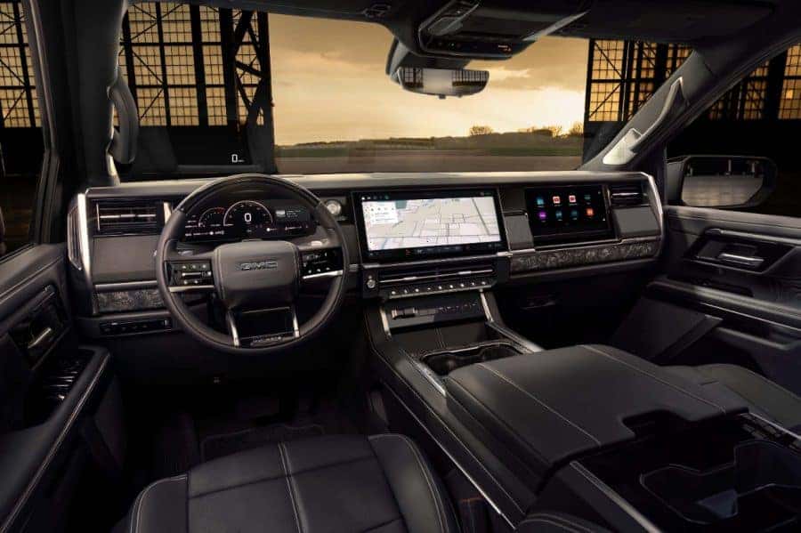 2027 GMC Sierra 1500 Denali Ultimate Stealth Black interior with Bright White accents. Interior full instrument panel. Preproduction model shown. Actual production model may vary.