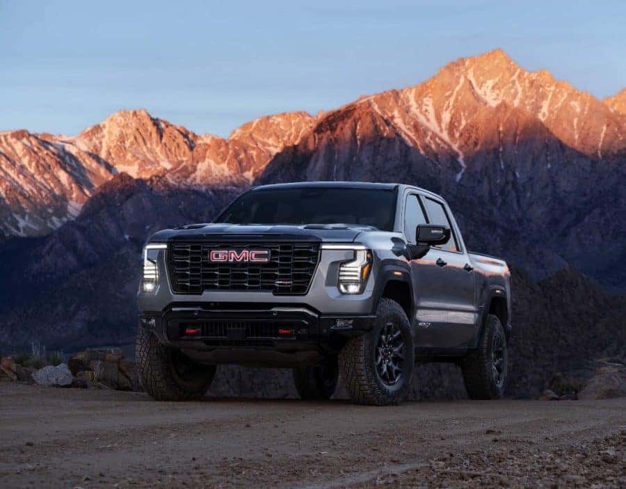 2027 GMC Sierra 1500 AT4X in Sterling Metallic. Exterior driver front 3/4 shot. Preproduction model shown. Actual production model may vary.