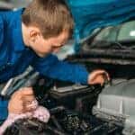 Service technician diagnosing engine issue