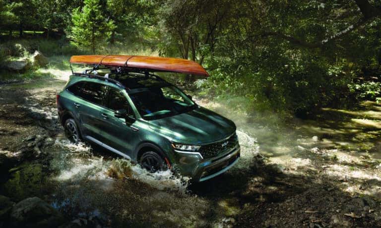 2026 Kia Sorento driving in stream with kayak