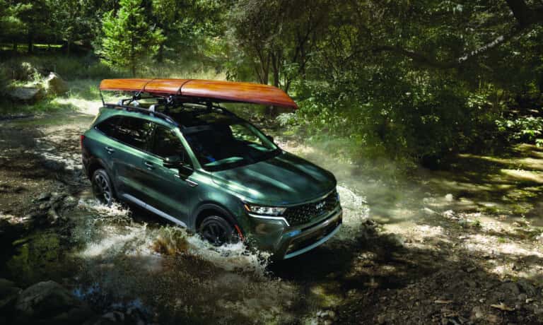 2026 Kia Sorento driving in stream with kayak