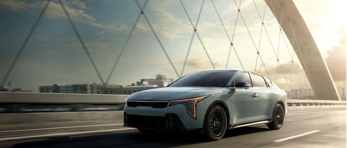2026 Kia K4 driving on a bridge