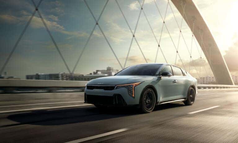 2026 Kia K4 driving on a bridge