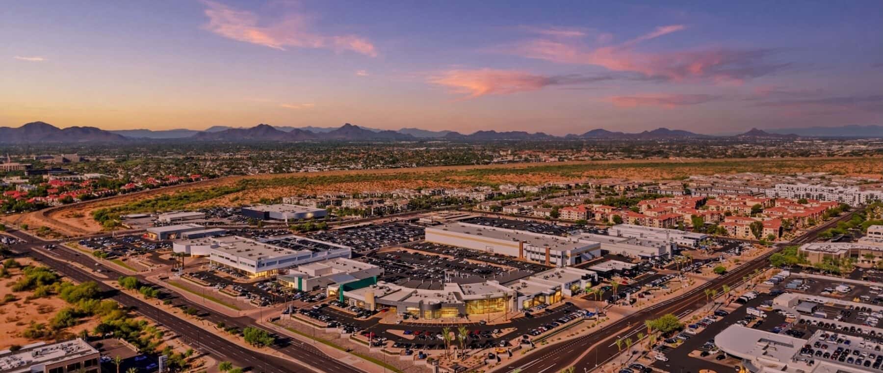 Aerial-View-of-a-Commercial-Complex-and-Mountains-at-Sunset