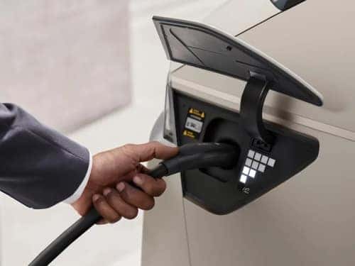 2025 Hyundai IONIQ 5 close up view of man charging vehicle