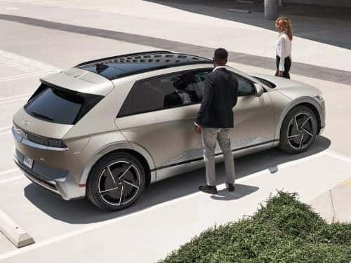 2025 Hyundai IONIQ 5 overhead exterior view of vehicle parked with couple standing around the outside