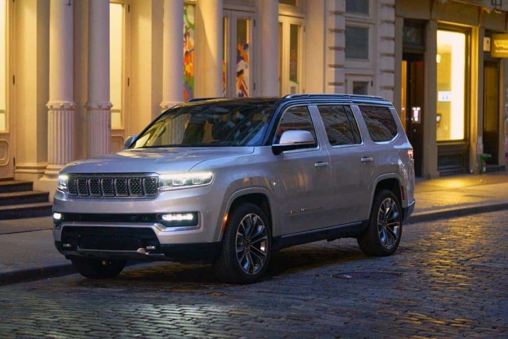 2022 Grand Wagoneer silver rainy city street