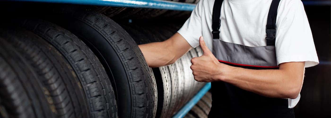 auto mechanic displaying new tires