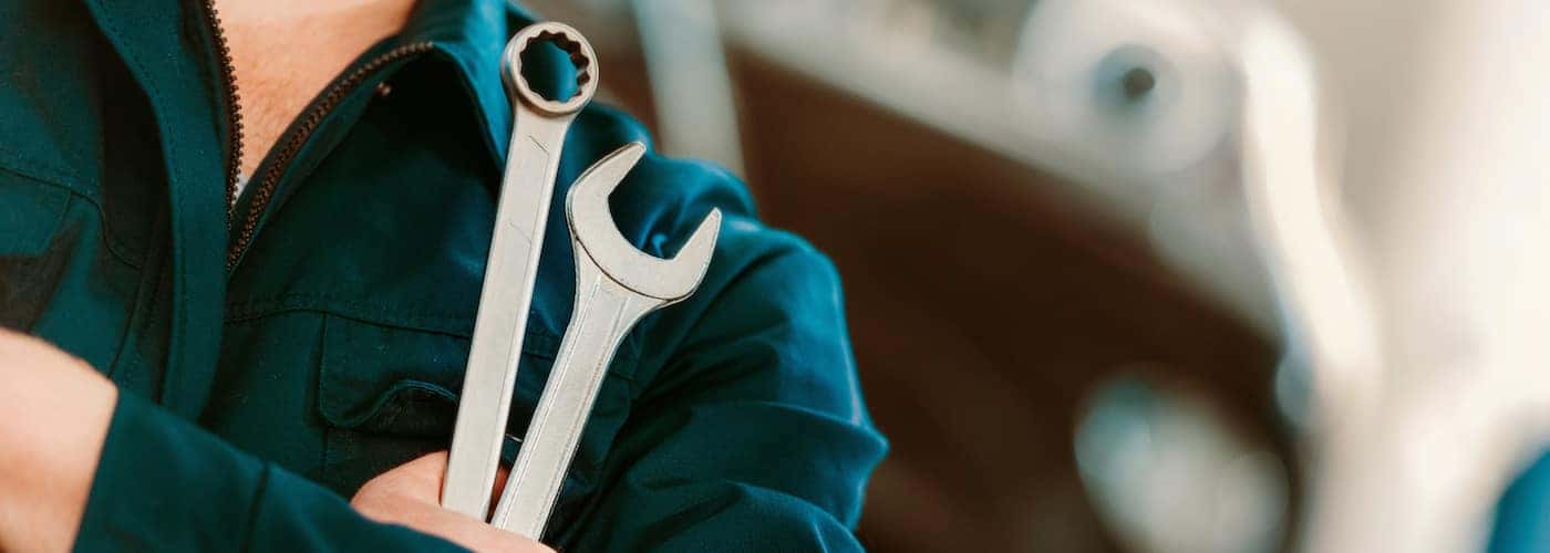 close up of mechanic holding wrenches