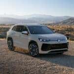 All New 2025 Volkswagen Tiguan parked in front of a sprawling mountain range