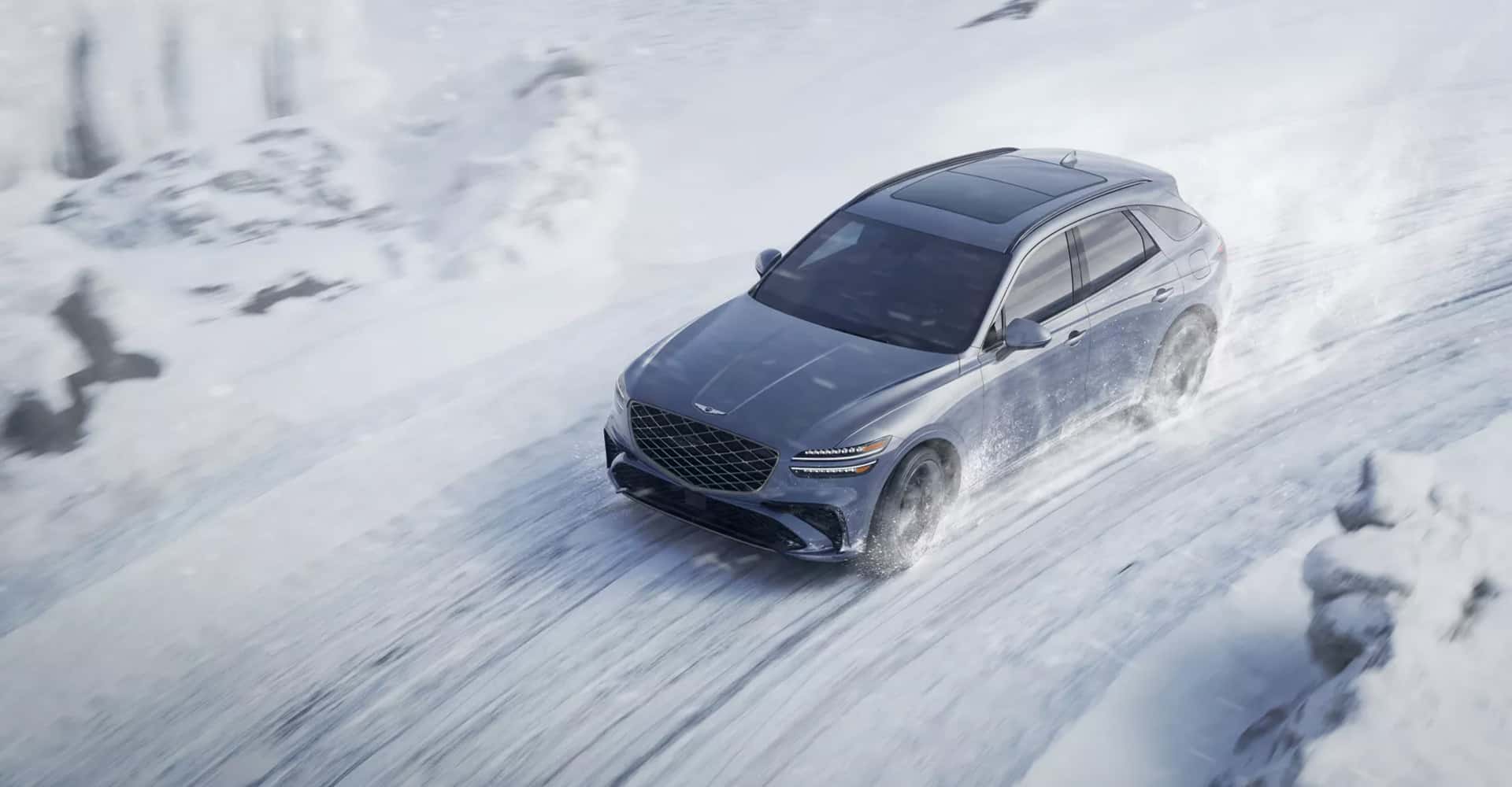 2026 Genesis GV70 driving on a snow-covered road