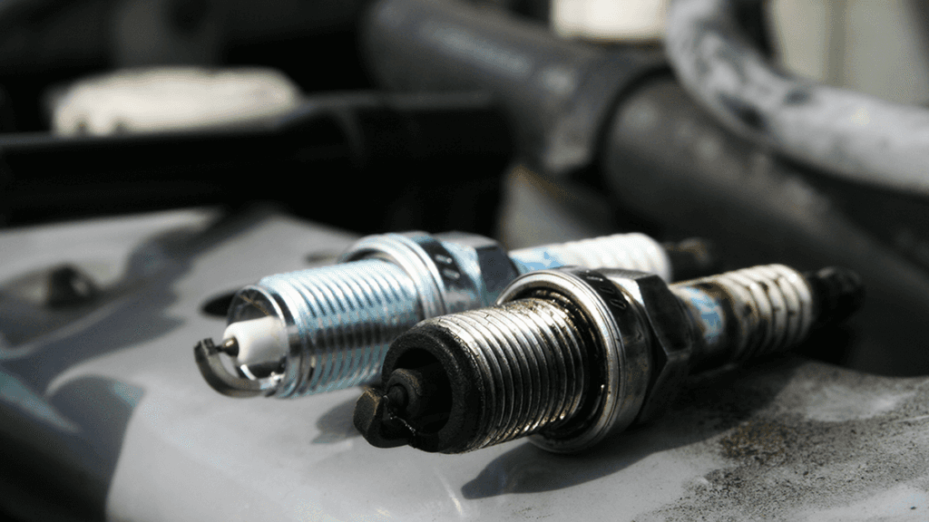 A comparison between a new and old spark plug