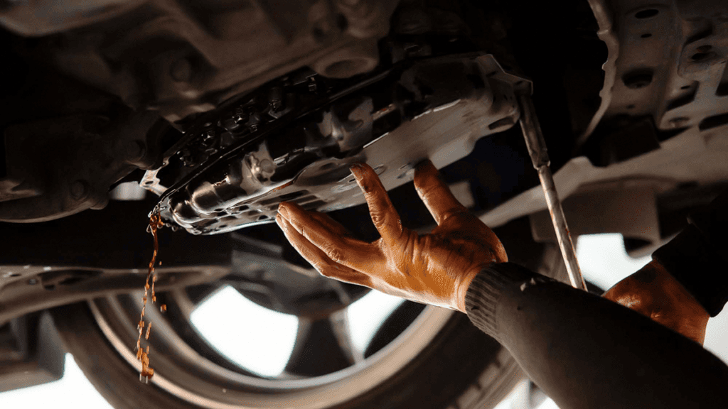 A technician performing a transmission fluid change
