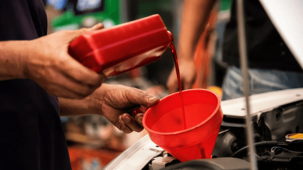 New transmission fluid being poured as part of a transmission fluid change