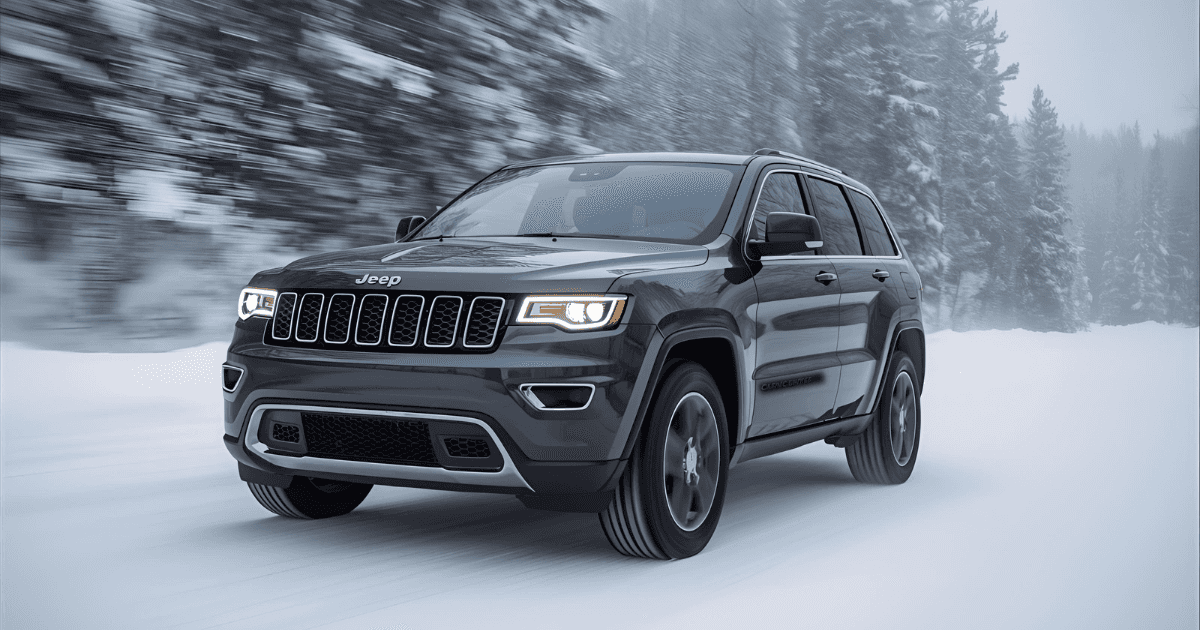 A 2025 Jeep Cherokee driving quickly down the snowy road