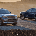 The 2025 Jeep grand Cherokee on a ridge with hazy mountains in the background