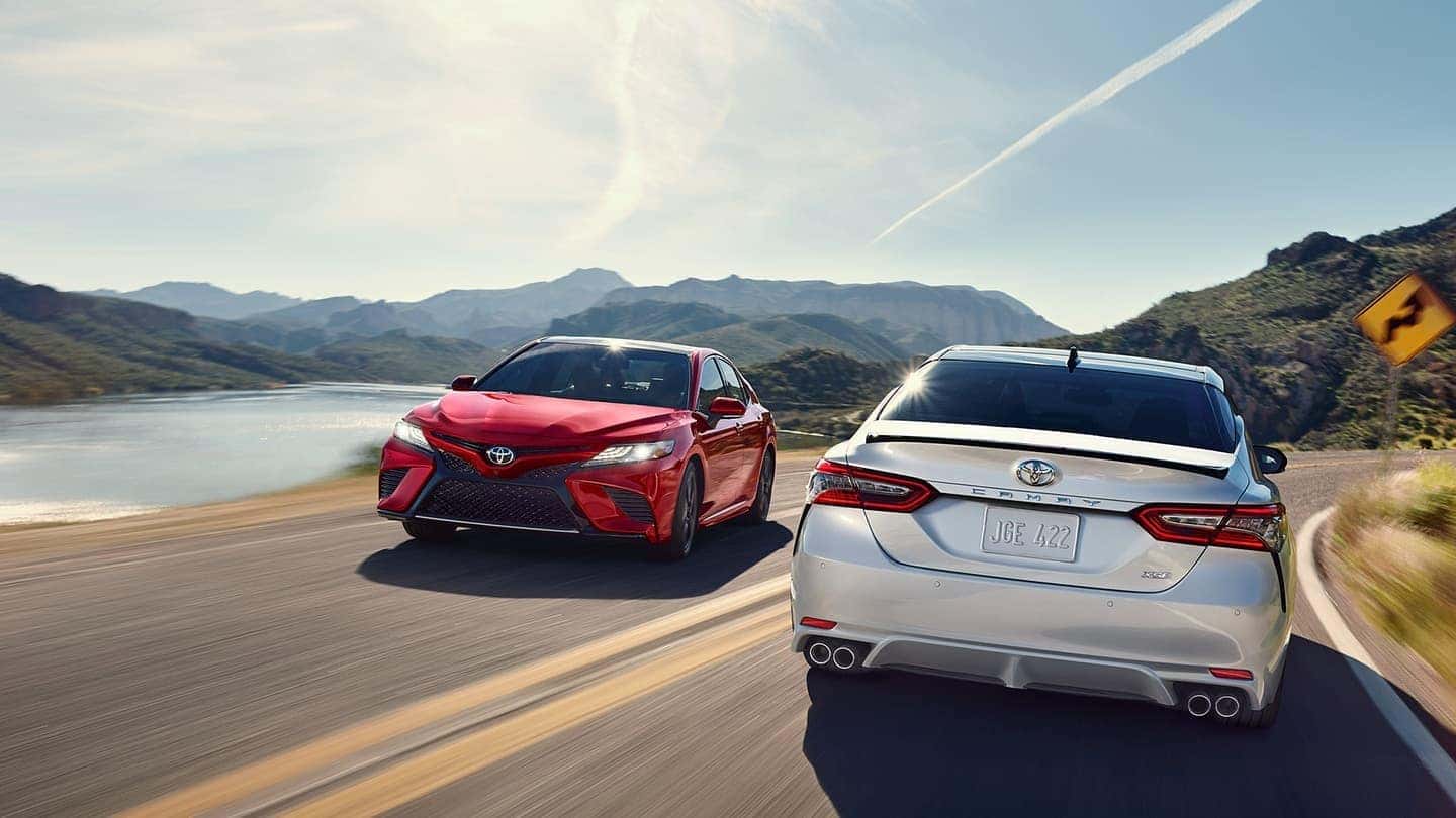 2019 Toyota Camry vehicles driving down road front and rear profile